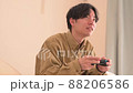Man playing games at home 88206586