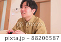 Man playing games at home 88206587