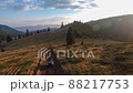 Aerial drone tracking shot driving off road car on mountain road at sunset 88217753