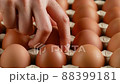 Hand takes one chicken egg out of cardboard, rotation shot 88399181