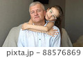Family portrait of mature father and little blonde daughter hugging at home while celebrating father's day 88576869