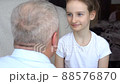Family portrait of mature father and little blonde daughter hugging at home while celebrating father's day 88576870