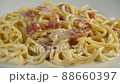carbonara spaghetti with cream on a white plate, rotation shot 88660397