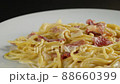carbonara spaghetti with cream on a white plate, rotation shot 88660399