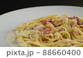 carbonara spaghetti with cream on a white plate, rotation shot 88660400