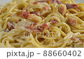 carbonara spaghetti with cream on a white plate, rotation shot 88660402