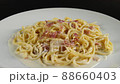 carbonara spaghetti with cream on a white plate, rotation shot 88660403