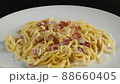 carbonara spaghetti with cream on a white plate, rotation shot 88660405