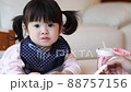 Girl happily eating baby food in the room 88757156