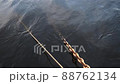 Chains and ropes on the pier going under the water 88762134