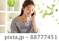 Young woman talking on a smartphone in the room 88777451