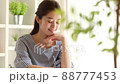 A young woman listening to the other person's story in the room while nodding 88777453