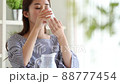 Young woman pouring milk in the room 88777454