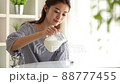 Young woman pouring milk in the room 88777455