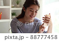 Young woman enjoying a smartphone game indoors 88777458