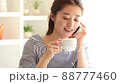Young woman making a mobile phone in the room 88777460
