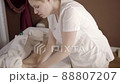 Professional female masseur doing anti-cellulite thigh massage for client at spa 88807207