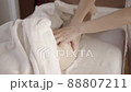 Professional female masseur doing anti-cellulite thigh massage for client at spa 88807211