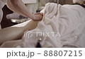 Professional female masseur doing anti-cellulite thigh massage for client at spa 88807215