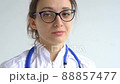 Female doctor is putting off protective blue gloves isolated on white background after some medical manipulations, vaccination. 88857477