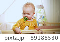 baby woke up and stands in crib 89188530