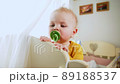 baby just woke up and is standing in crib 89188537