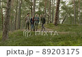 Group of people hiking in a forest 89203175