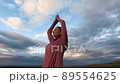woman doing yoga under sunset sky 89554625