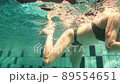 woman swimming underwater in pool 89554651