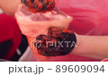 The butcher is marinating large piece of the fresh raw meat 89609094