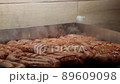 The sausages roasts on the electric grill at fast food eatery 89609098