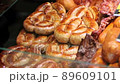Close-up of worker's hand puts the grilled sausage on display 89609101