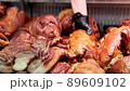 Close-up of salesman puts the smoked meat on the window display 89609102