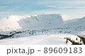 Mountain refuge in the middle of a snowy valley 89609183