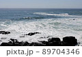 Rough waves hitting rocks in the Sea of Okhotsk in early spring 89704346