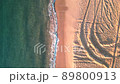 Drone shooting walking on a sandy beach 89800913