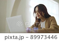 Excited asian female feeling euphoric celebrating online win success achievement result 89973446