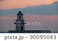 Lighthouse at sunset 90095043