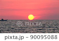 Timelapse, sunset with passing fishing boat at horizon 90095088