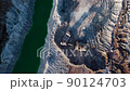 Excavator load limestone in mining truck in open pit mine. Haul truck transports chalk and clay  90124703