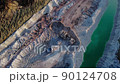 Excavator load limestone in mining truck in open pit mine. Haul truck transports chalk and clay  90124708