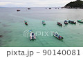 Amazing aerial view over beautiful tranquil azure bay with wooden fishing boats on ocean surface 90140081