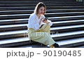 A woman operating a cell phone 90190485