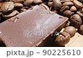 Extreme close-up of detailed coffee beans and bittersweet chocolate chunks with whole hazelnuts 90225610