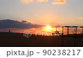 An airplane traveling on the Kumamoto Airport runway toward the setting sun 90238217