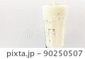 Pour the Milk in a glass on a white background. 90250507