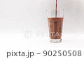 Pour the Chocolate flavored milk in a glass on a white background. 90250508