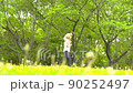 Parent and child playing in the park 90252497