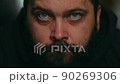 A man with a beard looks sadly at the camera and touches his beard, static camera, close-up of the face 90269306