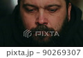 A man with a beard looks sadly at the camera, static camera, close-up of the face 90269307
